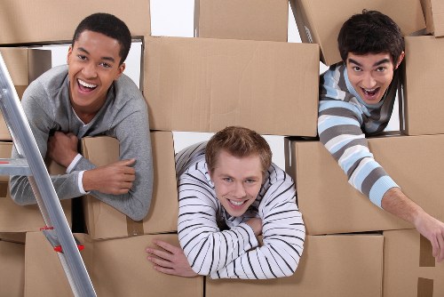 Local removals team handling boxes and furniture near Barnes