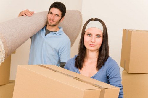 Loading furniture into a removals van on a Barnes residential street