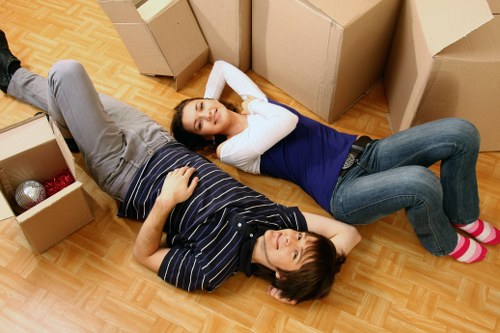 Packed boxes and furniture being loaded into a van